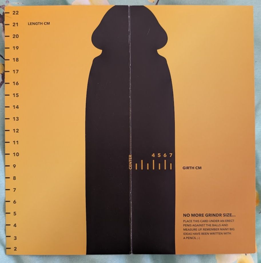 A yellow paper with the outline of an erect penis. Printed vertically are length markers and horizontally are girth markers. Both are in centimeters,