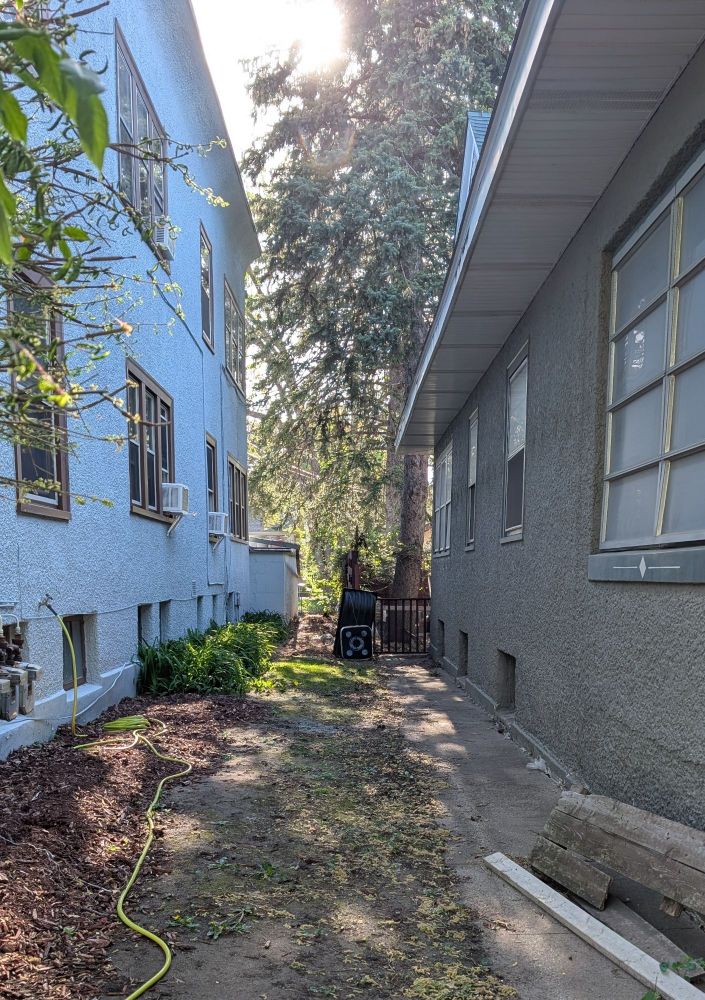 small archery target/cube between two houses
