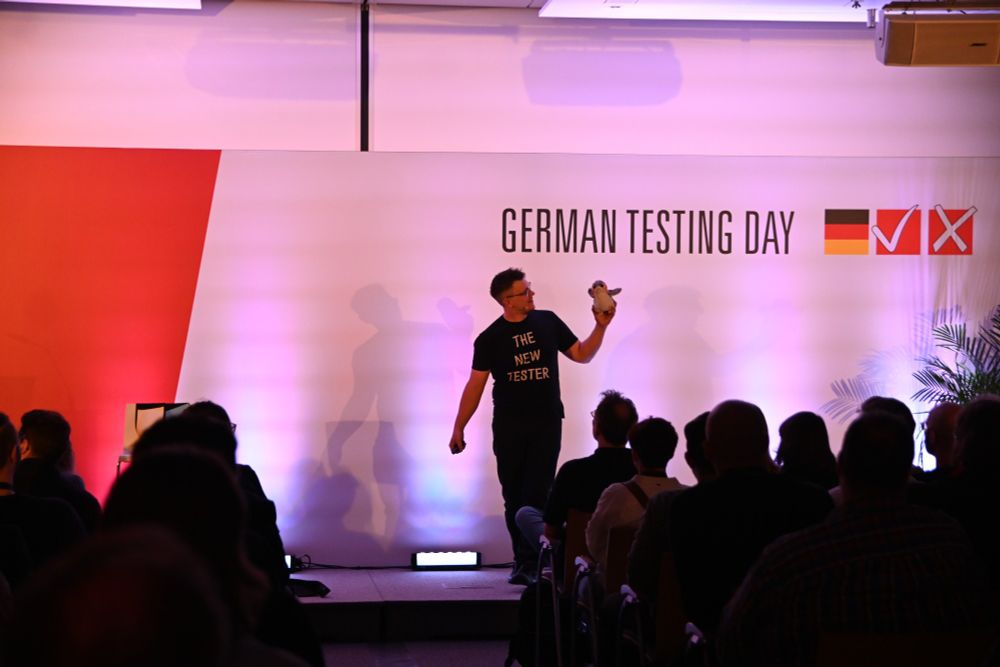 Tester Sam talking to Developer Kevin, a plush porg