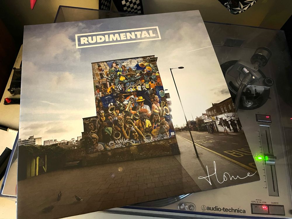Pic of Rudimental’s album “Home” atop a silver turntable.