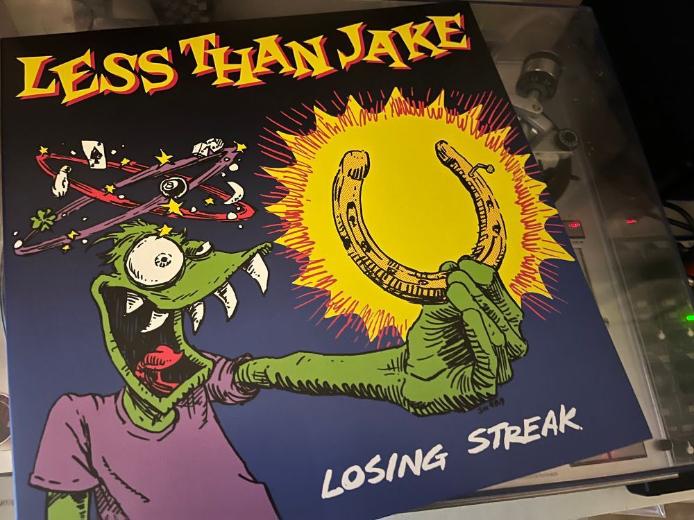 Pic of Less Than Jake’s album “Losing Streak” atop a silver turntable.