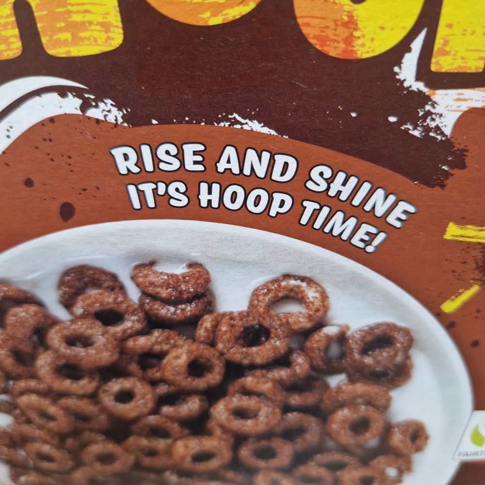 Box of generic chocolate hoops cereal with the slogan "Rise and shine. It's hoop time!"