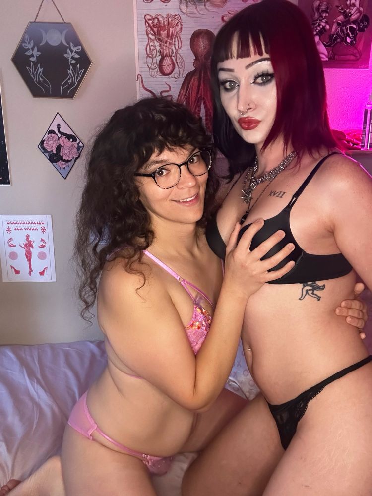 Velma and Raven smiling at camera in their underwear. Velma is grabbing Raven’s tit