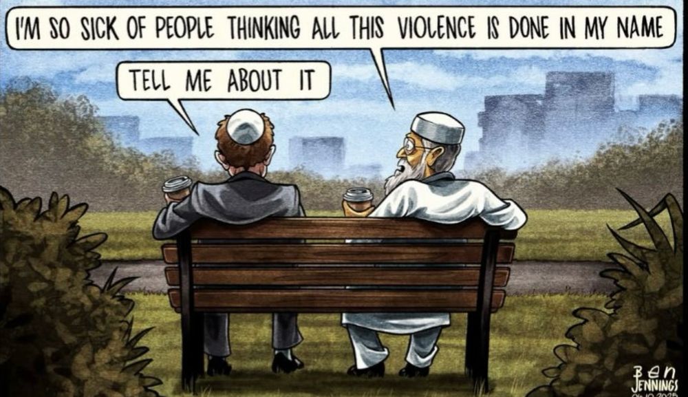 Image of a Jewish man and a Muslim man sat on a bench overlooking a city shadowed in smoke. Both are holding a coffee cup. The Muslim man says,”I’m so sick of people thinking all this violence is done in my name.” The Jewish man replies, “Tell me about it.”