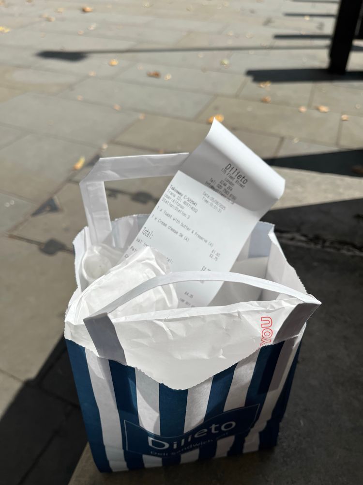 A blue and white striped paper bag for Dilieto sandwich bar with full
contents and a receipt for £4.35