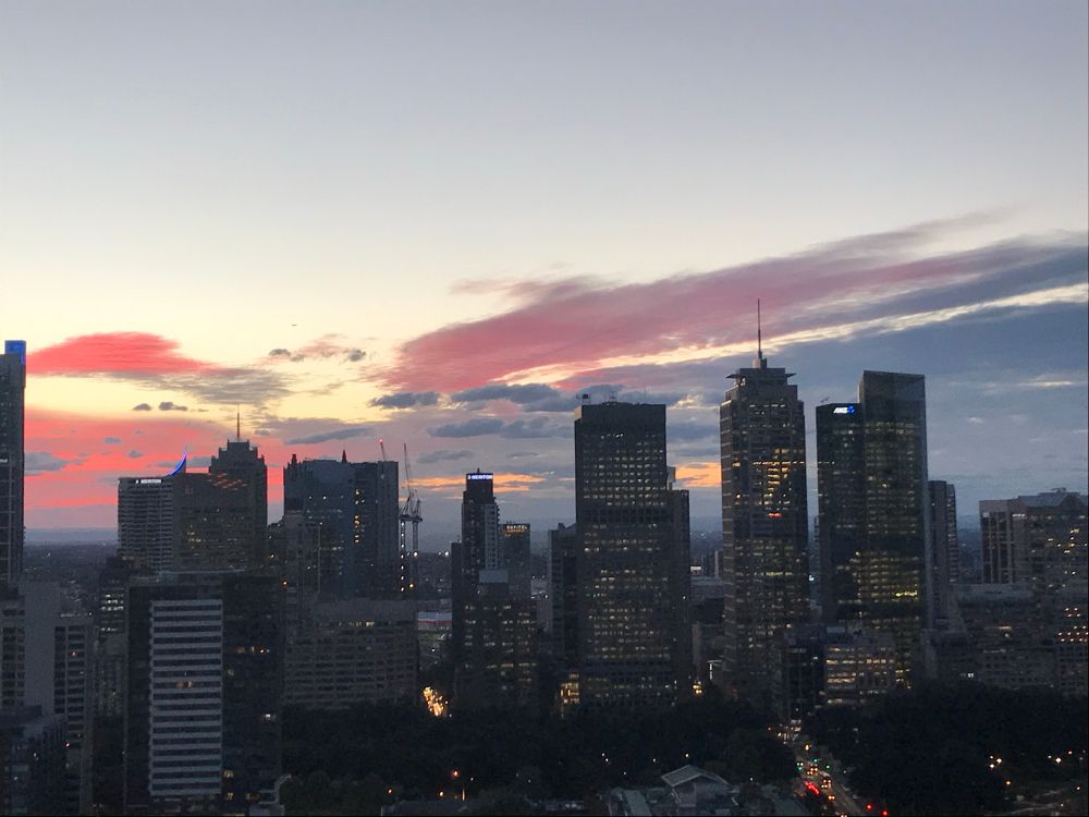 City skyline with lights coming on in some buildings and sunset background of pinks and blues on canvas of a pale sky. Taken after a Sydney working day now eight years ago exactly 