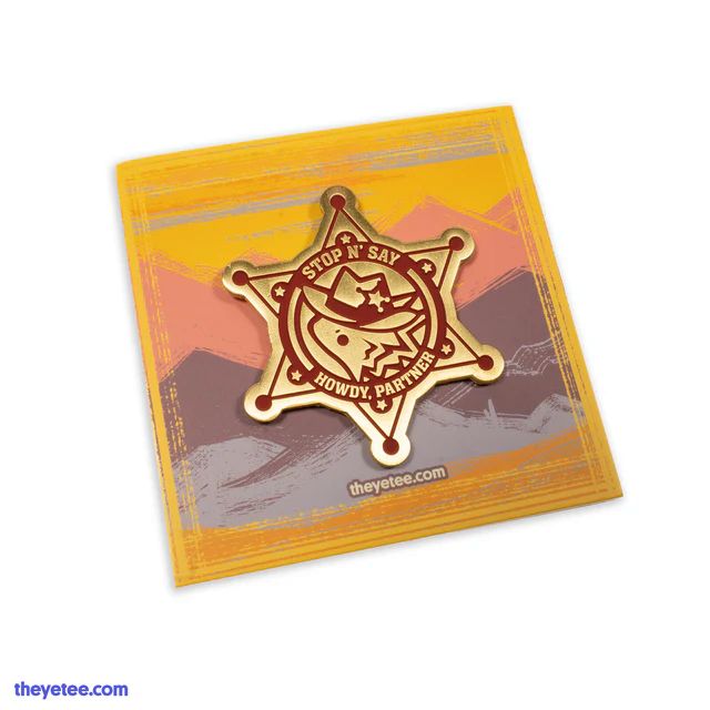 bronze sheriff badge pin that says "stop n' say howdy, partner" with a cowboy horned lizard