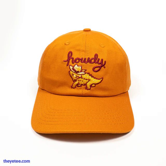 rusty orange dad style hat with the cowboy lizard with "howdy" text