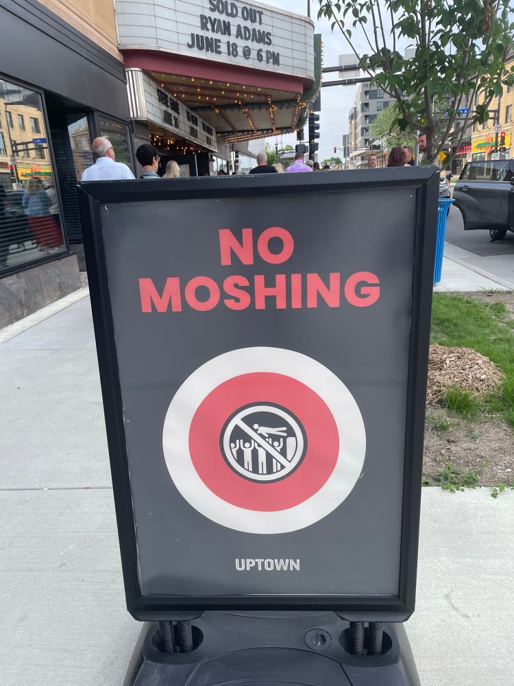 Sign saying “No Moshing” at a Ryan Adams solo show.