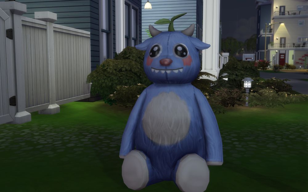 Pixel looks happy as they're sitting on the lawn outside the backyard fence.