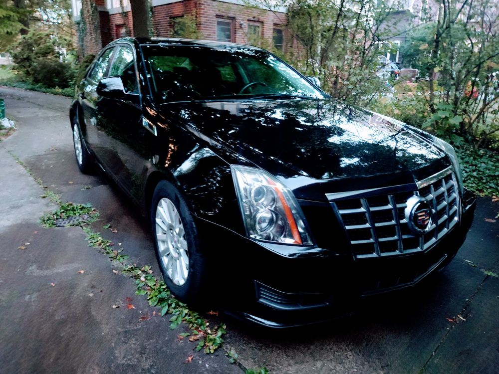 A black Cadillac CTS freshly washed and waxed