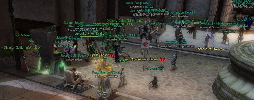 A cropped Guild Wars 2 screenshot showing buff banners with ArenaNet logos, laid by an employee/GM.