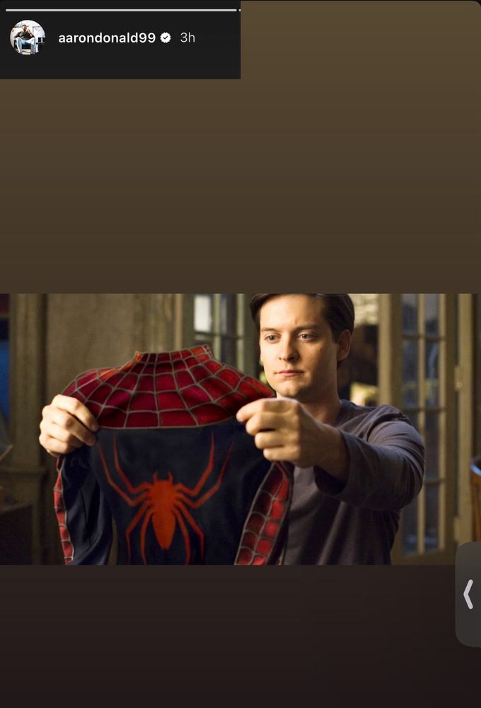 Aaron Donald posting a picture of Spider-Man holding his spider suit.