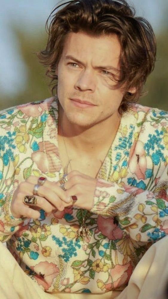 Harry Styles in the sun in a flowery shirt 