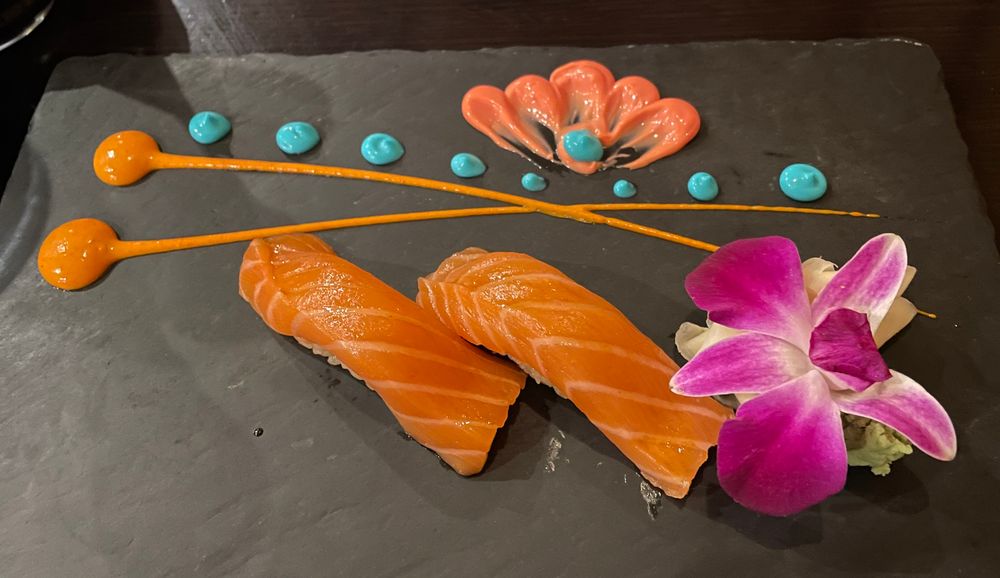 One order of nigiri salmon decorated like crazy 
