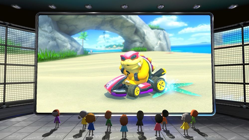 Miis watching Roy Koopa on a giant screen in Mario Kart 8