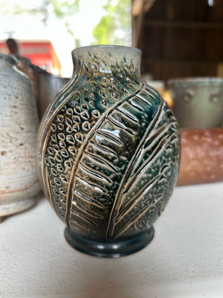 Carved vase with blue-green flashing slip