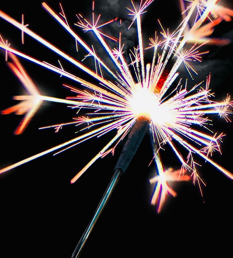 A sparkler firework mid-light