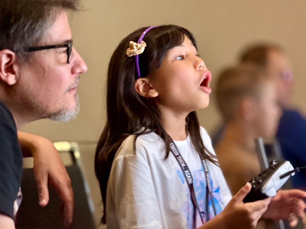 Father and daughter crack the Storyteller day. 