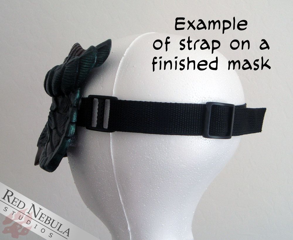 A photo of the back of a wig form with a mask strapped onto it and the text "Example of strap on a finished mask"