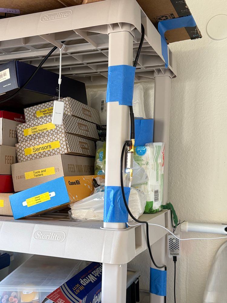 Electronic stuff attached to my storage shelves. Some with blue tape.