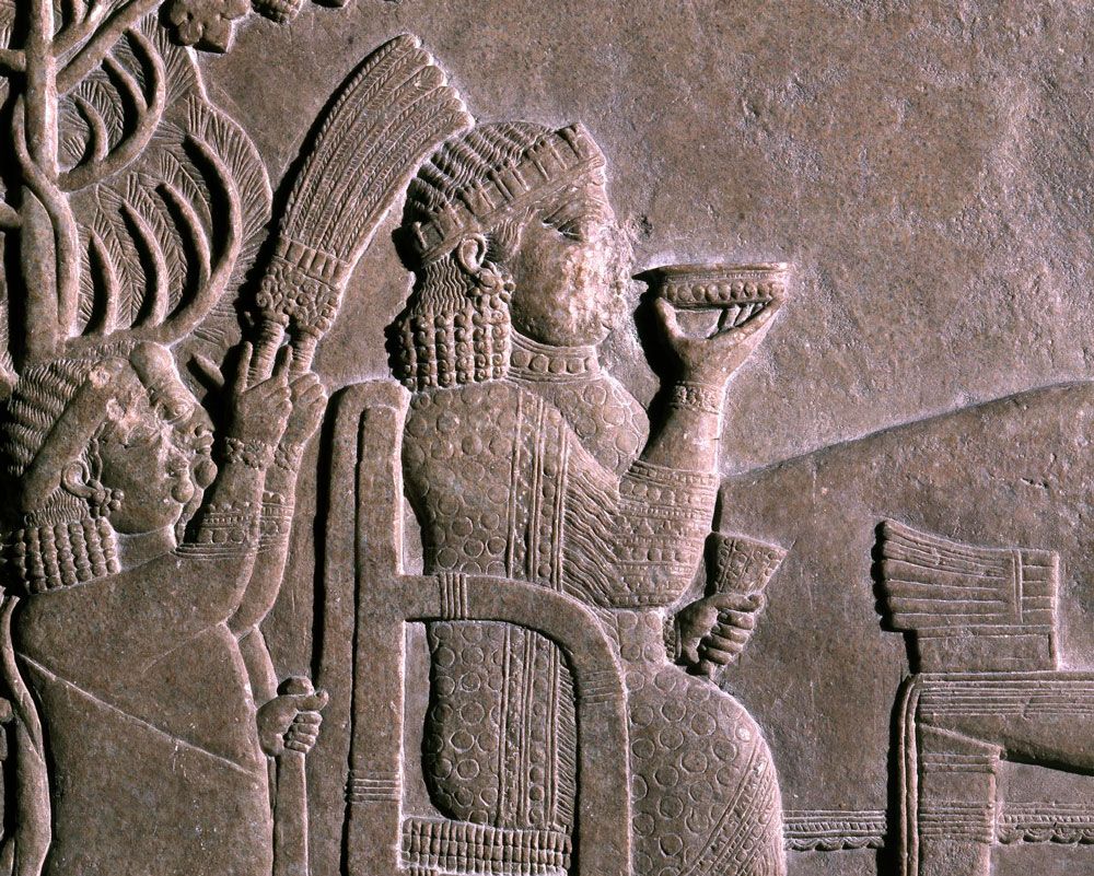 The queen drinks a cup of wine, Banquet under the vine arbour of Ashurbanipal in Nineveh (7th century BCE). Photo: The Trustees of the British Museum