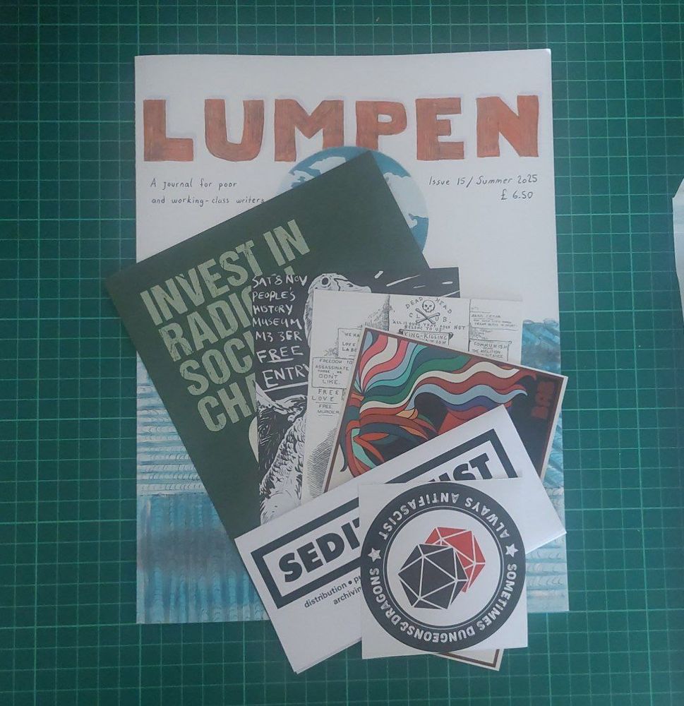 A photograpph of a magazine and several postcards and sticker items.