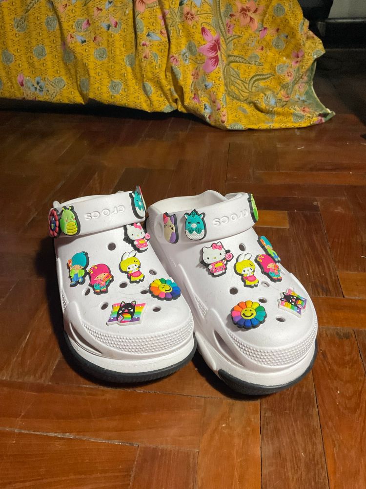 a pair of white, platform crocs with altogether too many jibbitzez, including Hello Kitty, Kiki&Lala, MyMelody, Doraemon’s flower, a Pride flag and some other random lil’ guys.  I probably need help :)