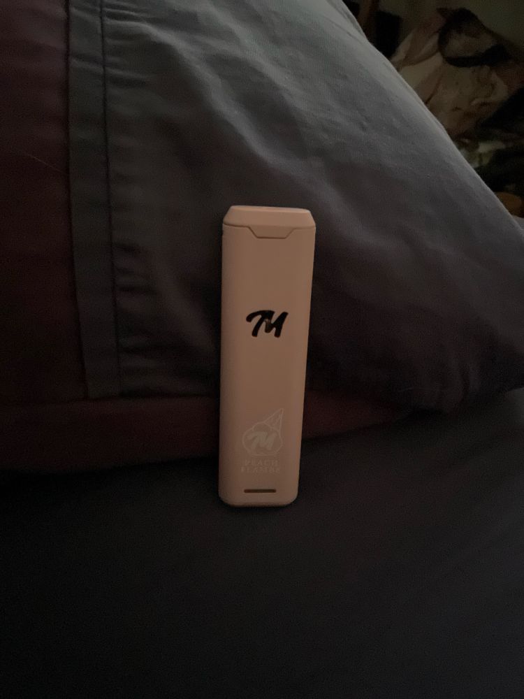 Close up of a pale pink Melt Exotics Peach Flambé vape