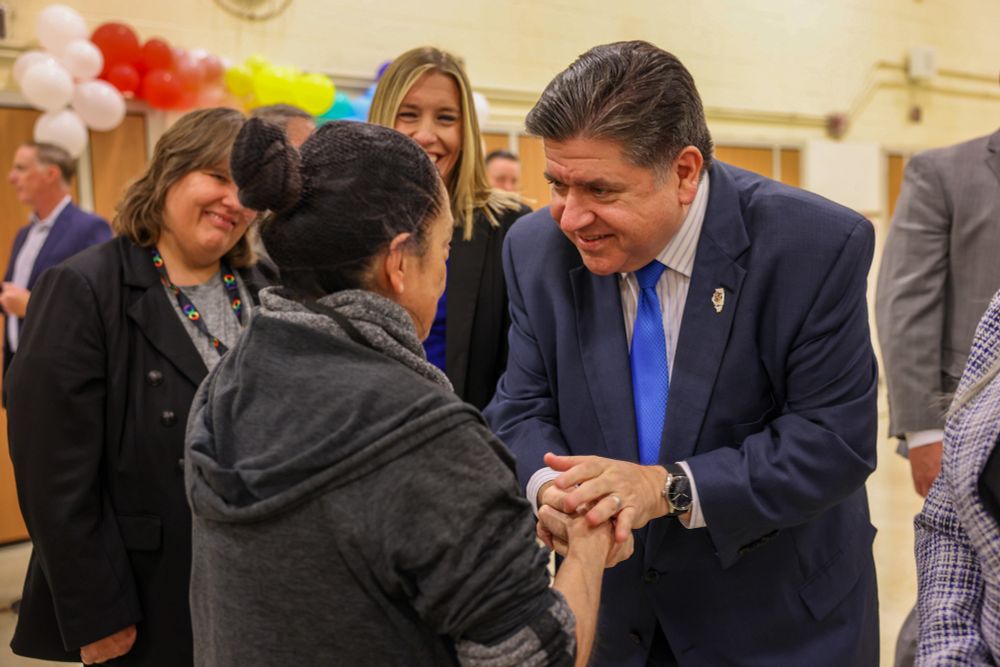 Governor Pritzker shakes hands with employees of Glen Oaks Elementary.