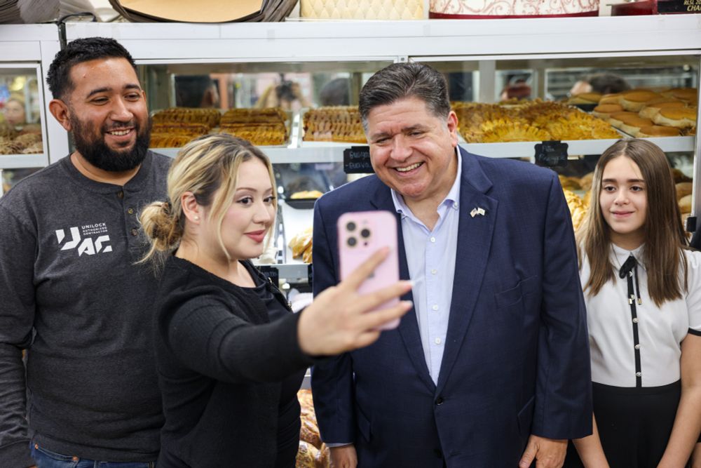 Governor Pritzker poses for a photo.