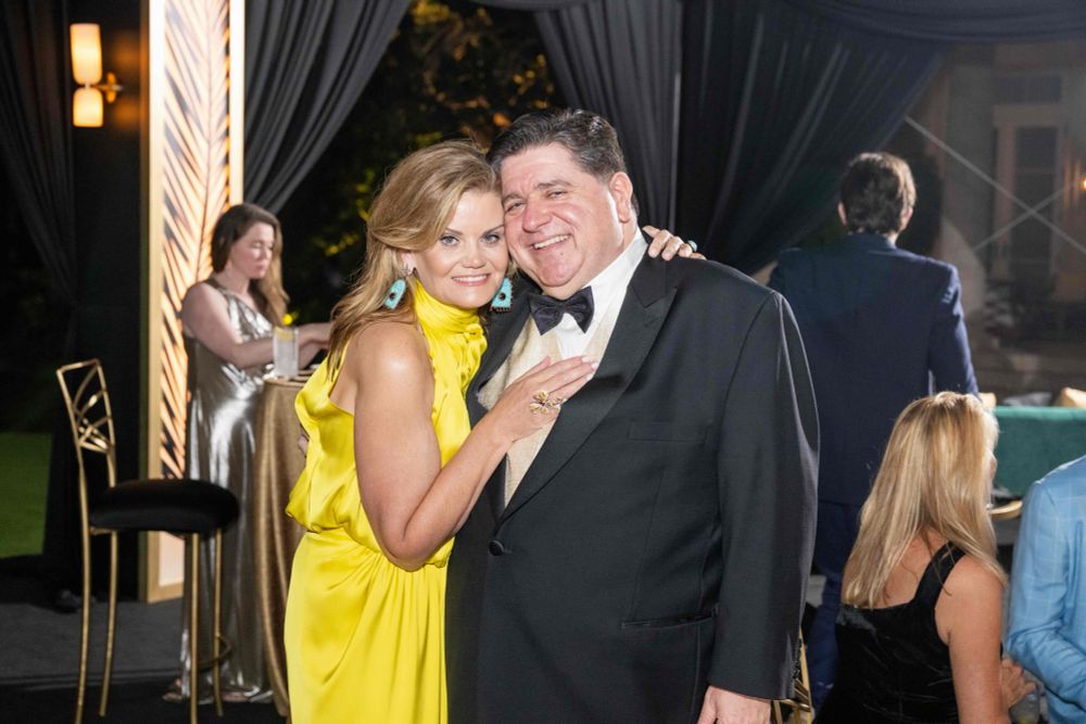 Governor Pritzker and the First Lady pose for a photo.