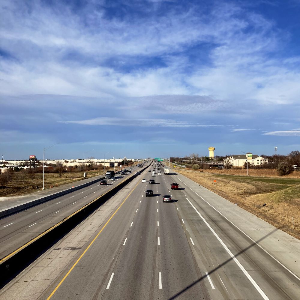 I-80 through Urbandale, and interstate highway with four lanes in one direction with three to four in the other direction.