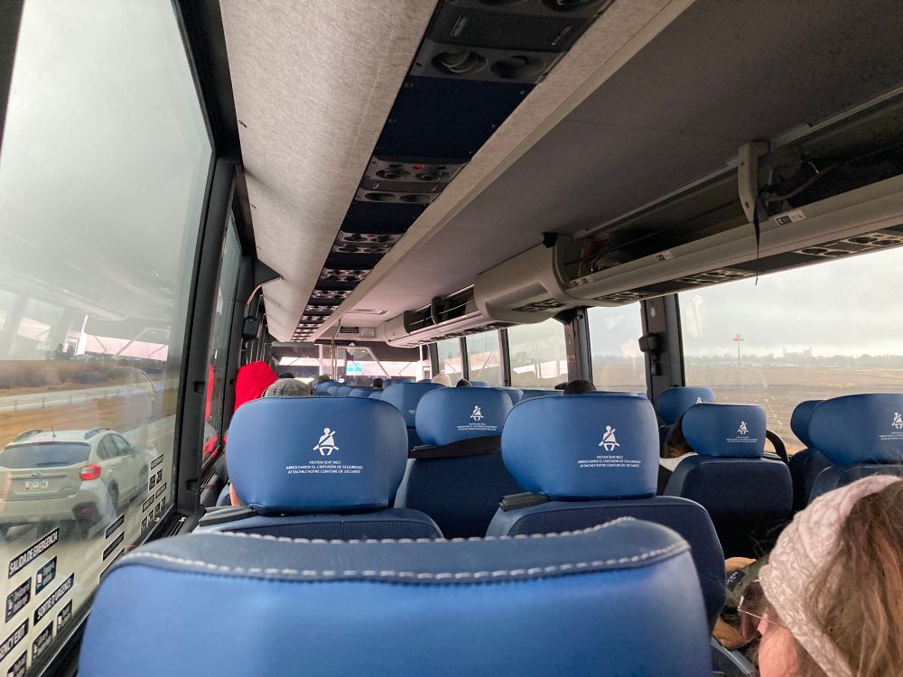 The interior of a Greyhound motorcoach, with winged headrests.