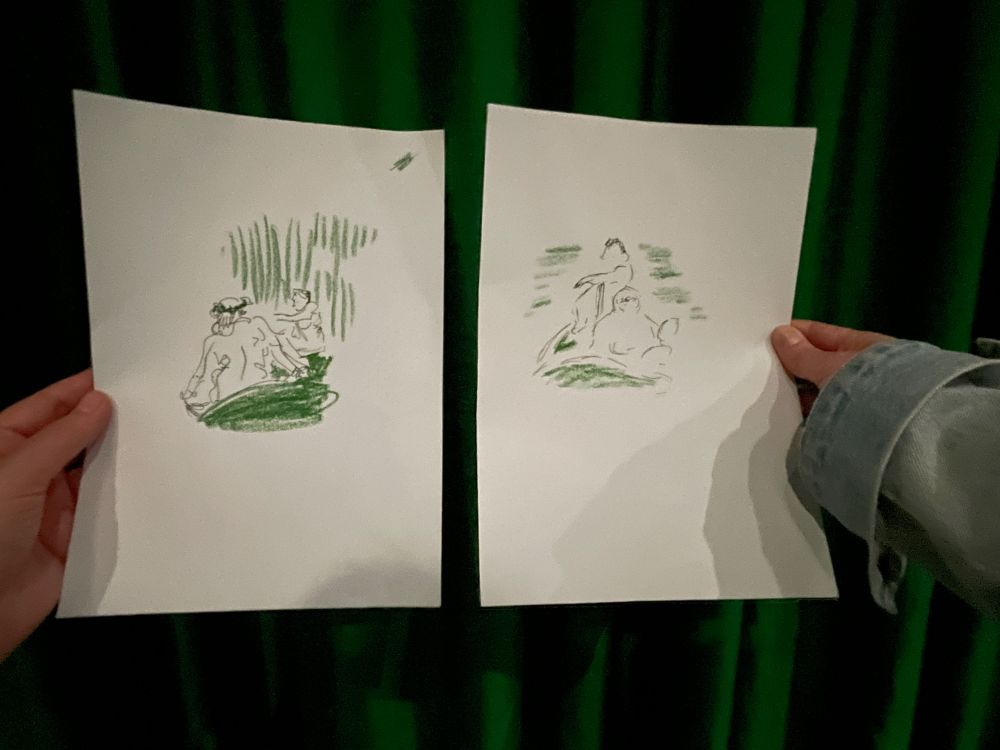 Hands holding sketches in black pen and green pastel, each of two figures lounging 