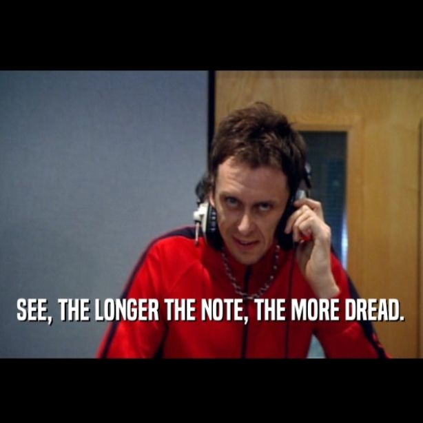 Super Hans from Peep Show wearing headphones and saying "see, the longer the note, the more dread."