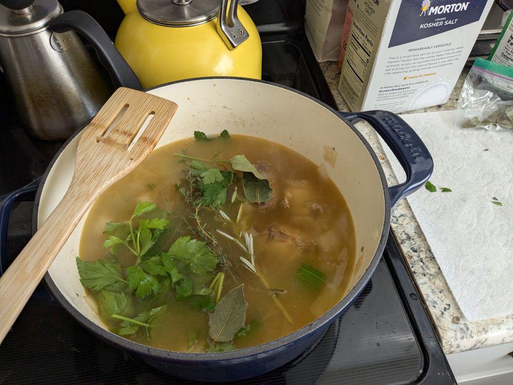 Now the ditch oven has stock added as well as the herbs