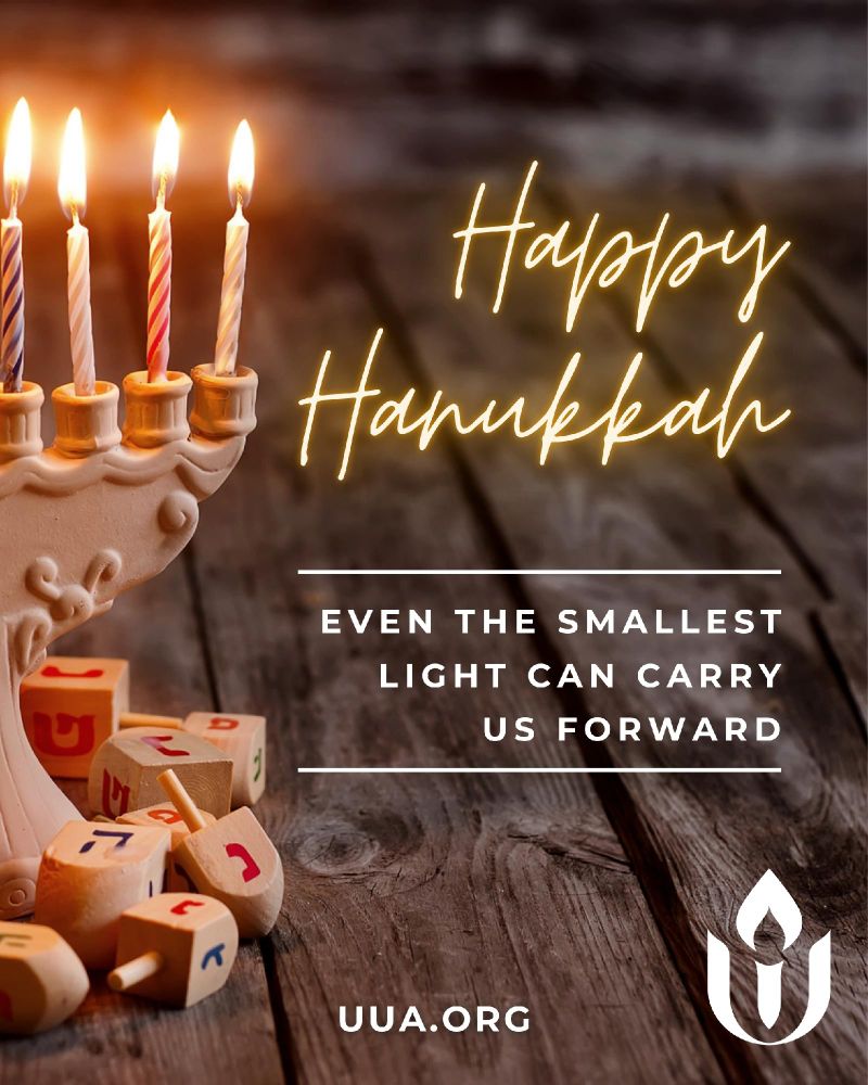 A photo of a lit Hanukkah menorah on a wooden surface. Five candles are visible, each with a small flame. Several wooden dreidels with Hebrew letters are scattered at the base of the menorah. On the right side of the image, glowing script text reads “Happy Hanukkah.” Below it, centered white text says “Even the smallest light can carry us forward,” with thin horizontal lines above and below the phrase. The UUA flaming chalice logo appears in the bottom right corner. The URL “http://UUA.org ” is centered near the bottom.