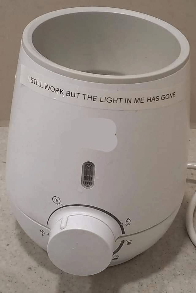 Warmer that says “I STILL WORK BUT THE LIGHT IN ME HAS GONE”