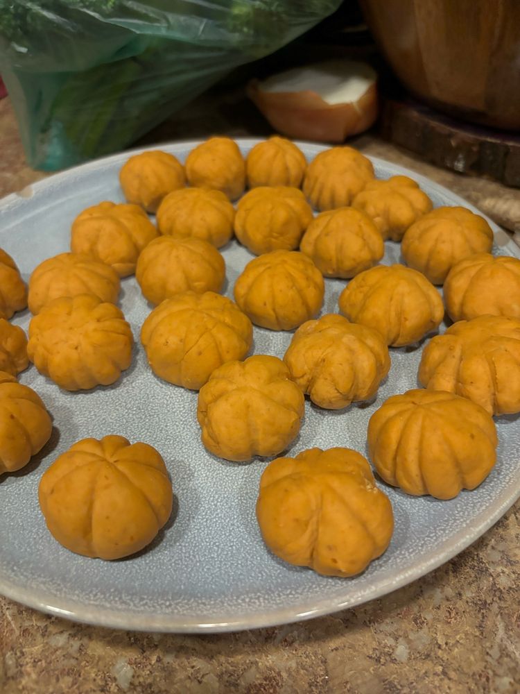 little pumpkin flavored gnocchi shaped like pumpkins with pumpkin seeds for stems 