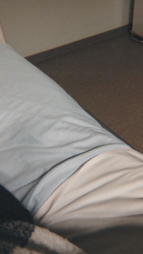 The edge of a hospital bed.