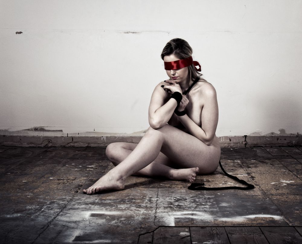 Naked woman in a derelict room