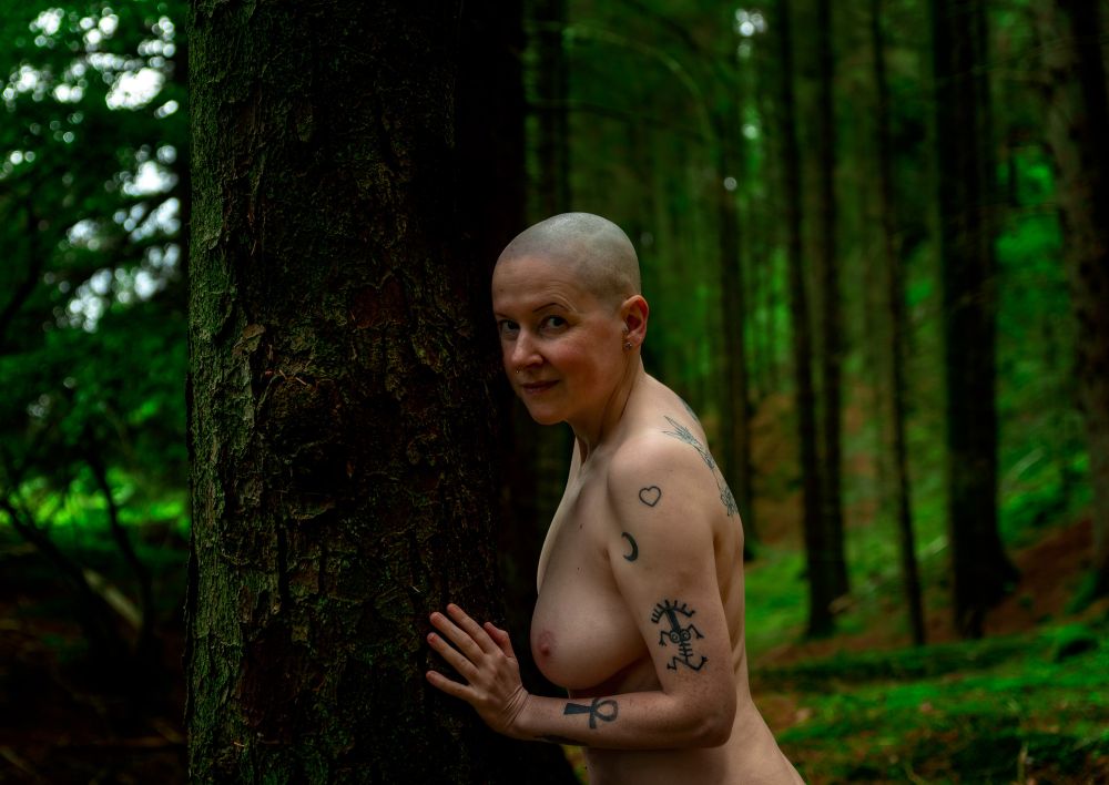 topless female in a forest