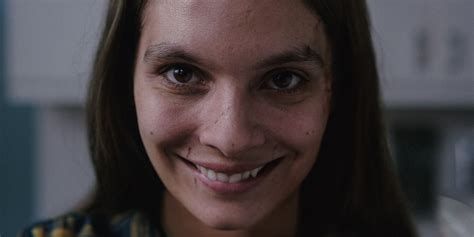 A still from the movie Smile, featuring a lady with a smile that could be nice but is actually really damn creepy.