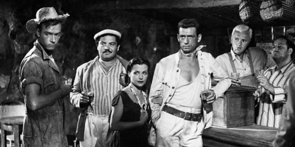 Most of the cast of The Wages of Fear, hanging out at a shitty cantina and being shitty to each other. Just real miserable people. It's awesome.