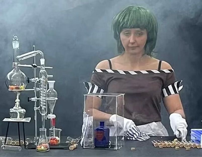 A photo of a sad woman in a green wig and striped costume next to a whimsical chemistry set at the infamous Willy’s Chocolate Experience in Glasgow, Scotland. “Underwhelming” does not begin to describe the level of half-assness here.