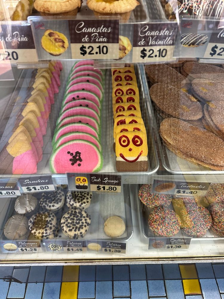 a picture of a bread and cookie case at a panaderia 