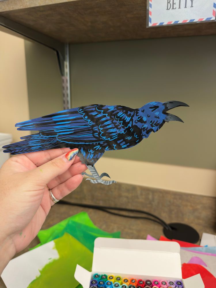 paper cutout of a cawing crow