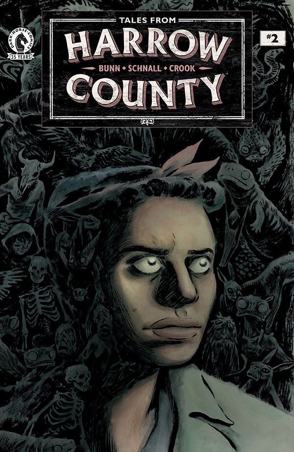 “Tales From Harrow County: Fair Folk #2” Cover: A woman gazing with determination, all around in the shadows are different monsters and creatures