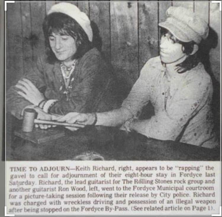 TIME TO ADJOURN-Keith Richard, right, appears to be "rapping" the gavel to call for adjournment of their eight-hour stay in Fordyce last Saturday. Richard, the lead guitarist for The Rolling Stones rock group and another guitarist Ron Wood, left, went to the Fordyce Municipal courtroom for a picture-taking session following their release by City police. Richard was charged with wreckless driving and possession of an illegal weapon after being stopped on the Fordyce By-Pass. (See related article on Page 1).